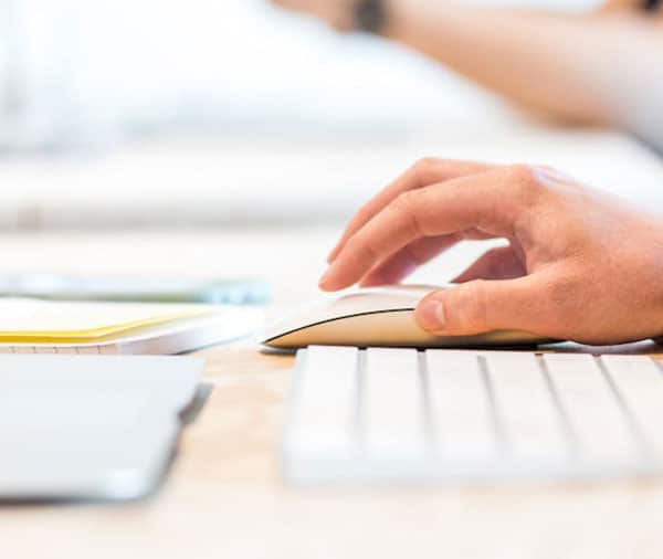 Person-at-PC-with-mouse-in-hand